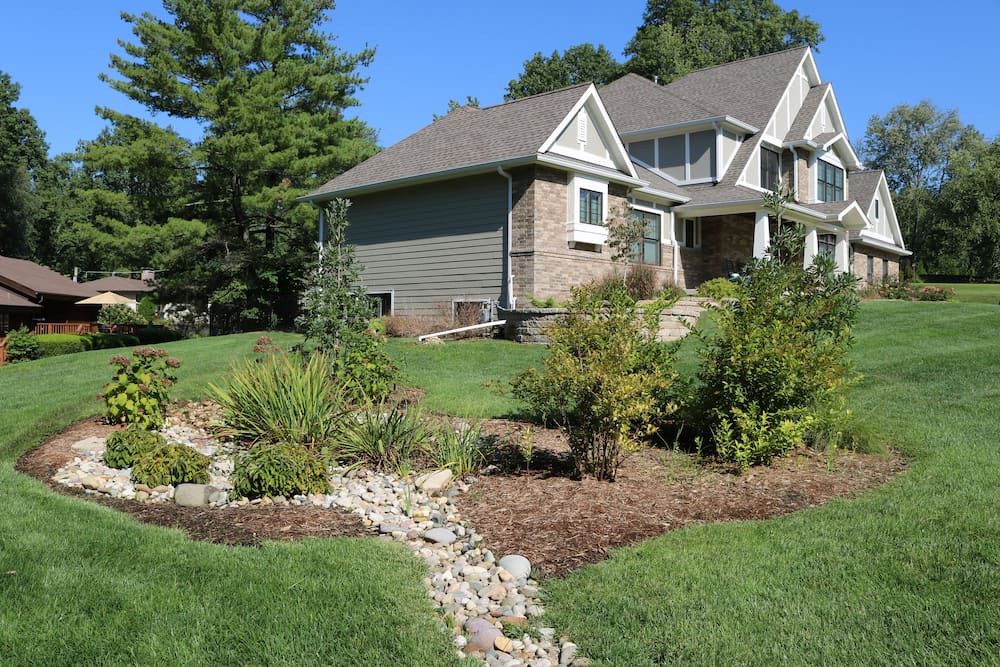French drain installation in St. Louis yard protecting foundation from water buildup