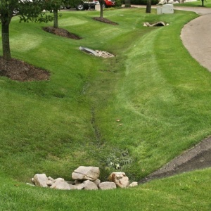 French drain installation in St. Louis yard protecting foundation from water buildup