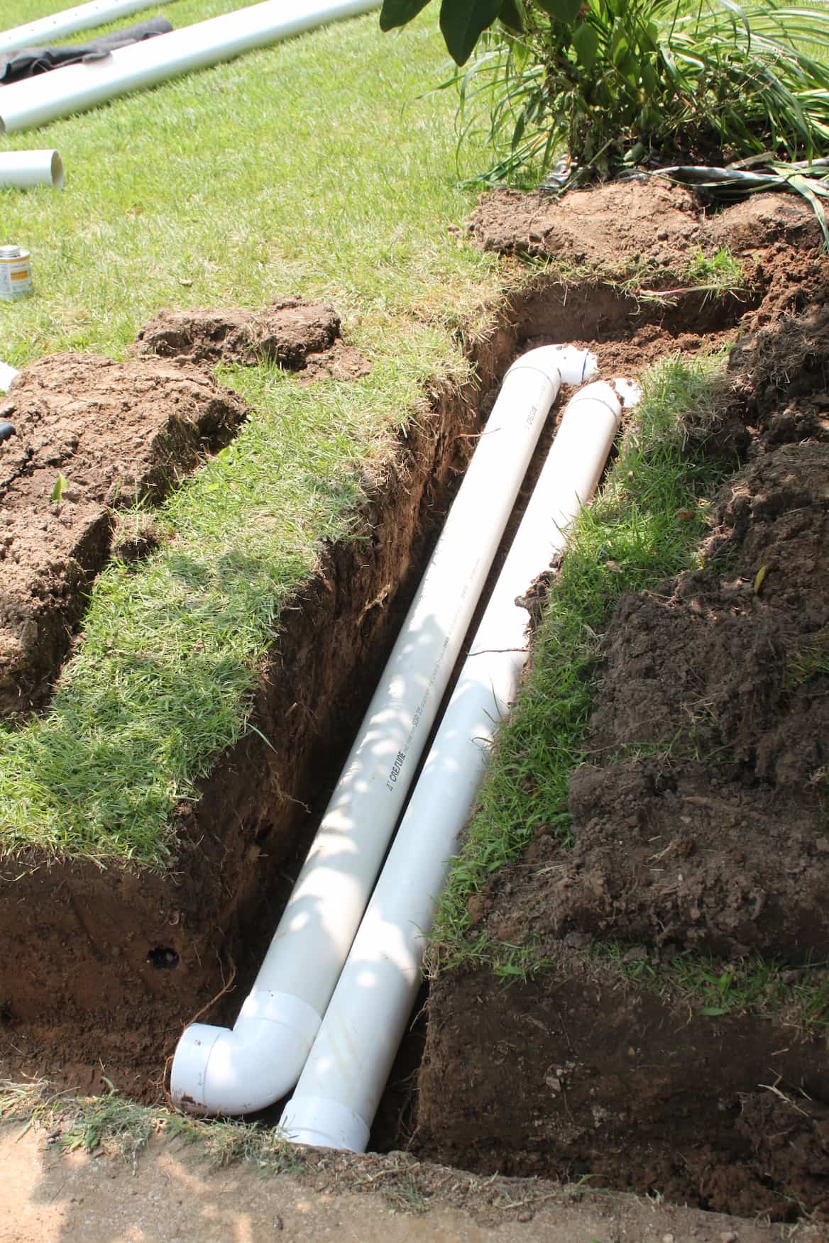 French drain installation in St. Louis yard protecting foundation from water buildup