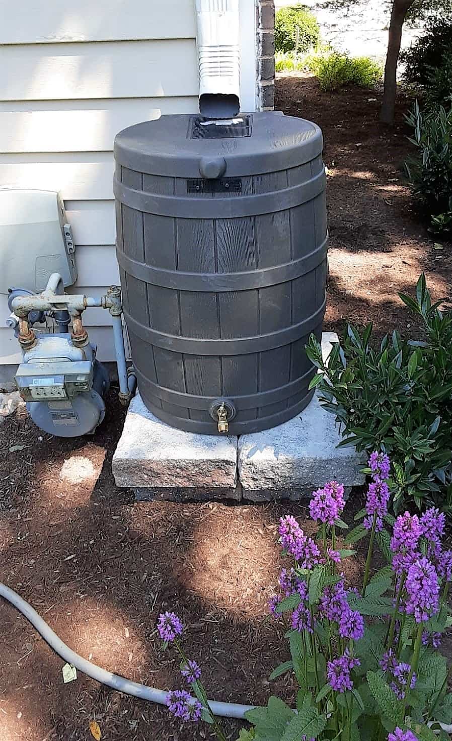 French drain installation in St. Louis yard protecting foundation from water buildup