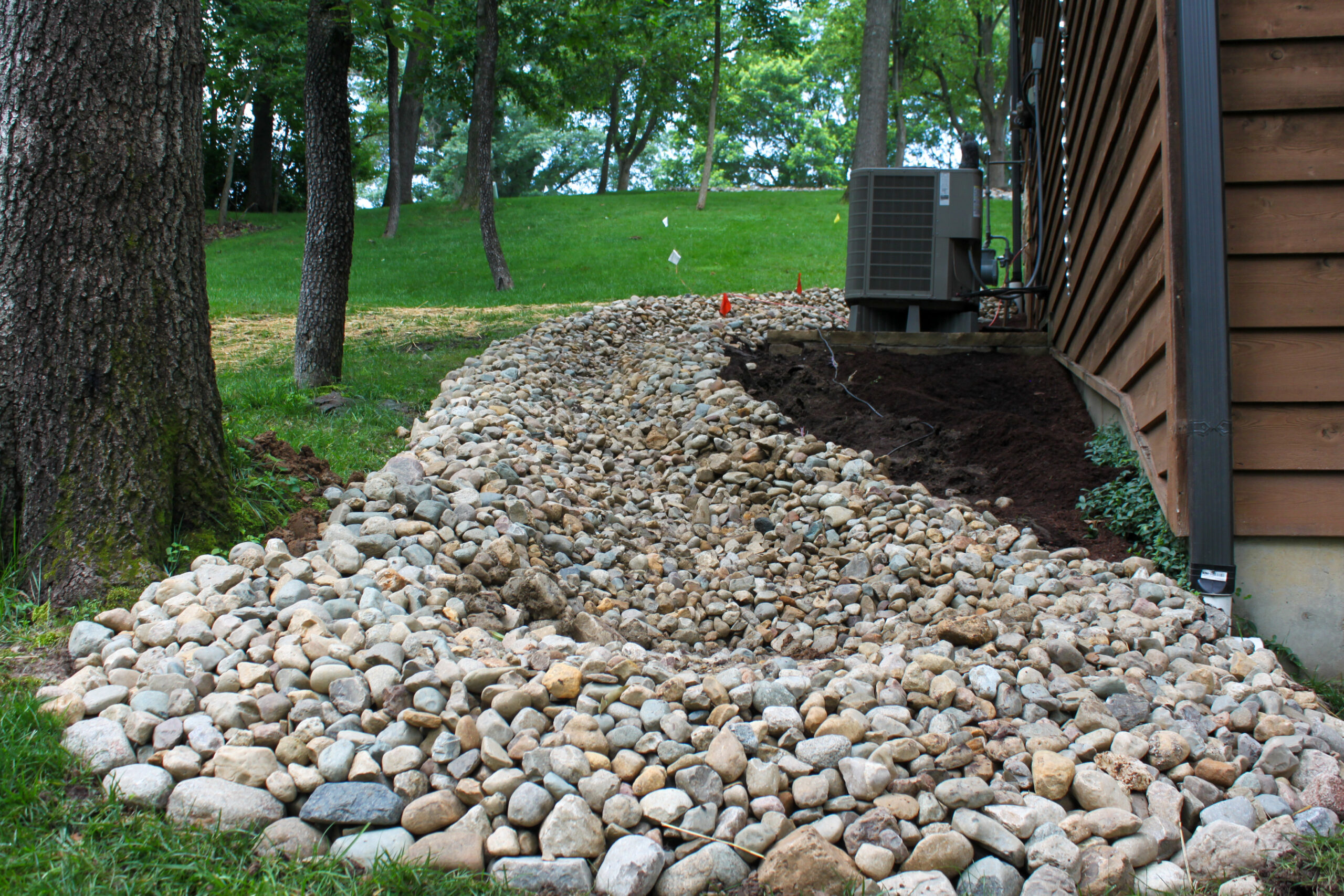 Dry creek bed drainage through a garden