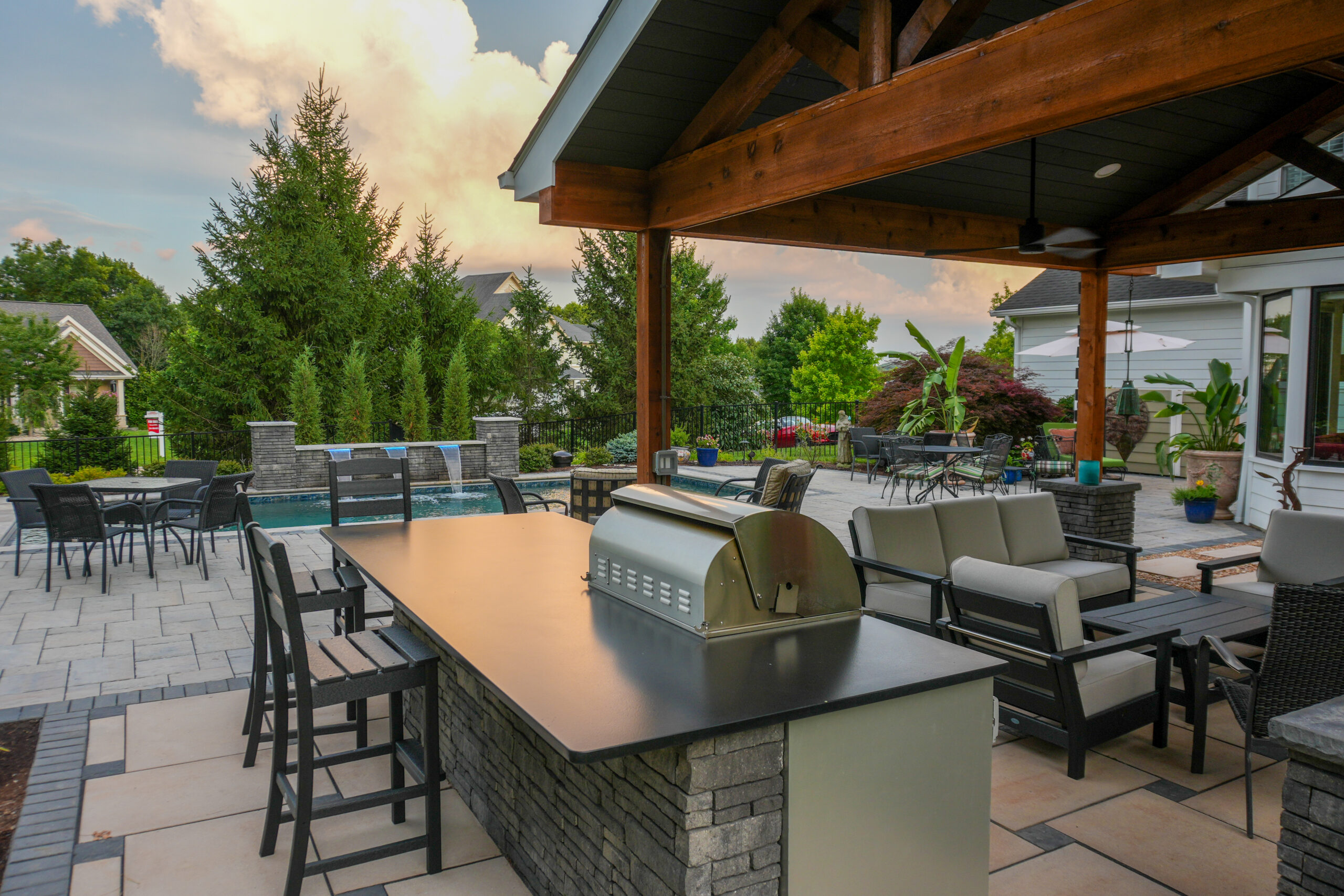 Finished outdoor kitchen on a patio, counter and grill, evening light