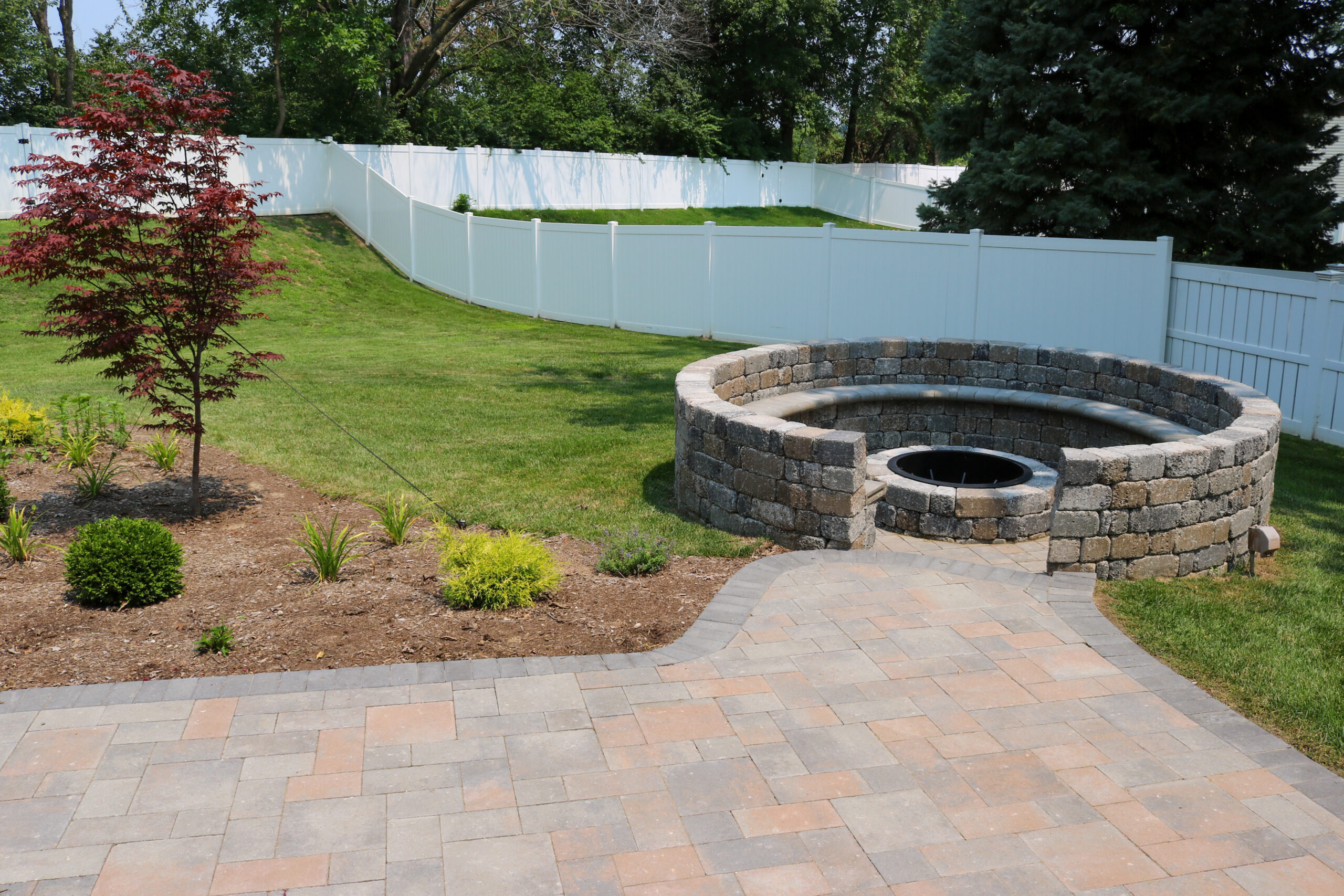 Stone fire pit at the end of a gravel path