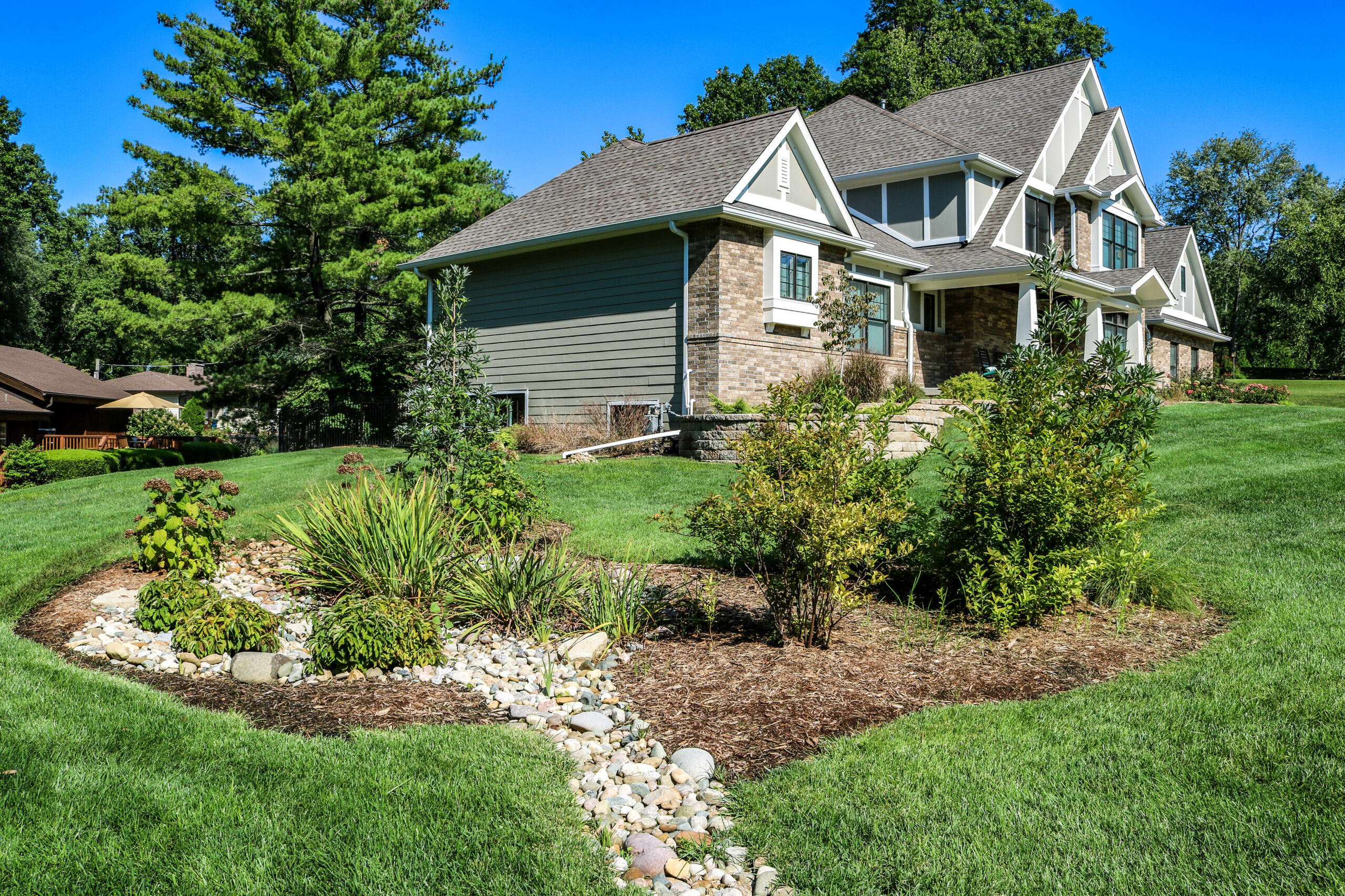 Dry creek bed drainage through a garden