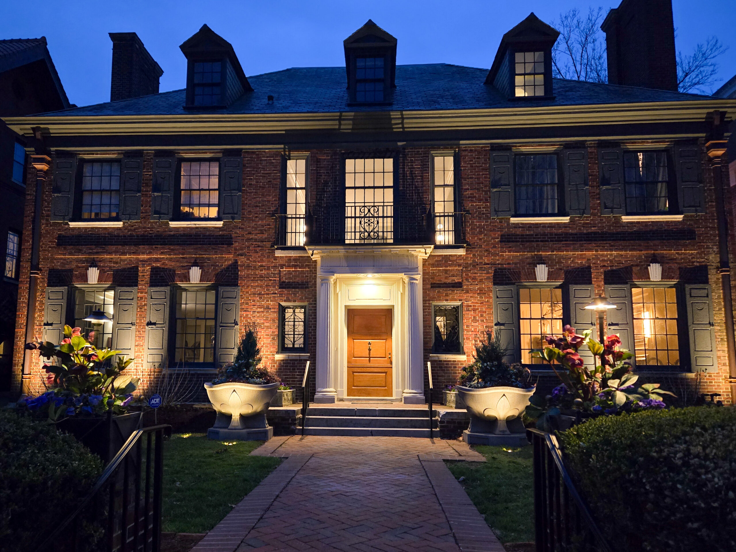 Outdoor lighting around a patio and fire feature after dark