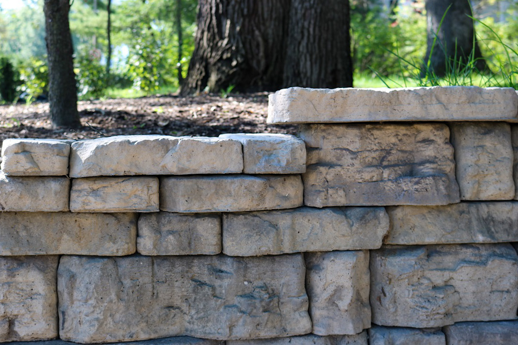Photograph: boulder wall lining a curved drive